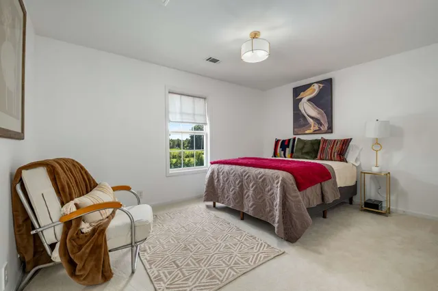 a bed room with a bed and a chair