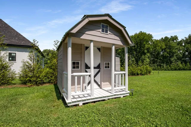 an aerial view of a house with swimming pool and garden