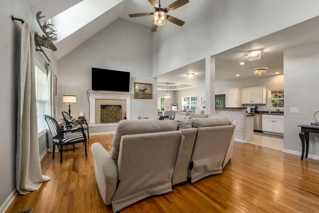 a living room with furniture fireplace and a flat screen tv