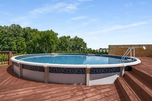 a view of green field with tree in the background