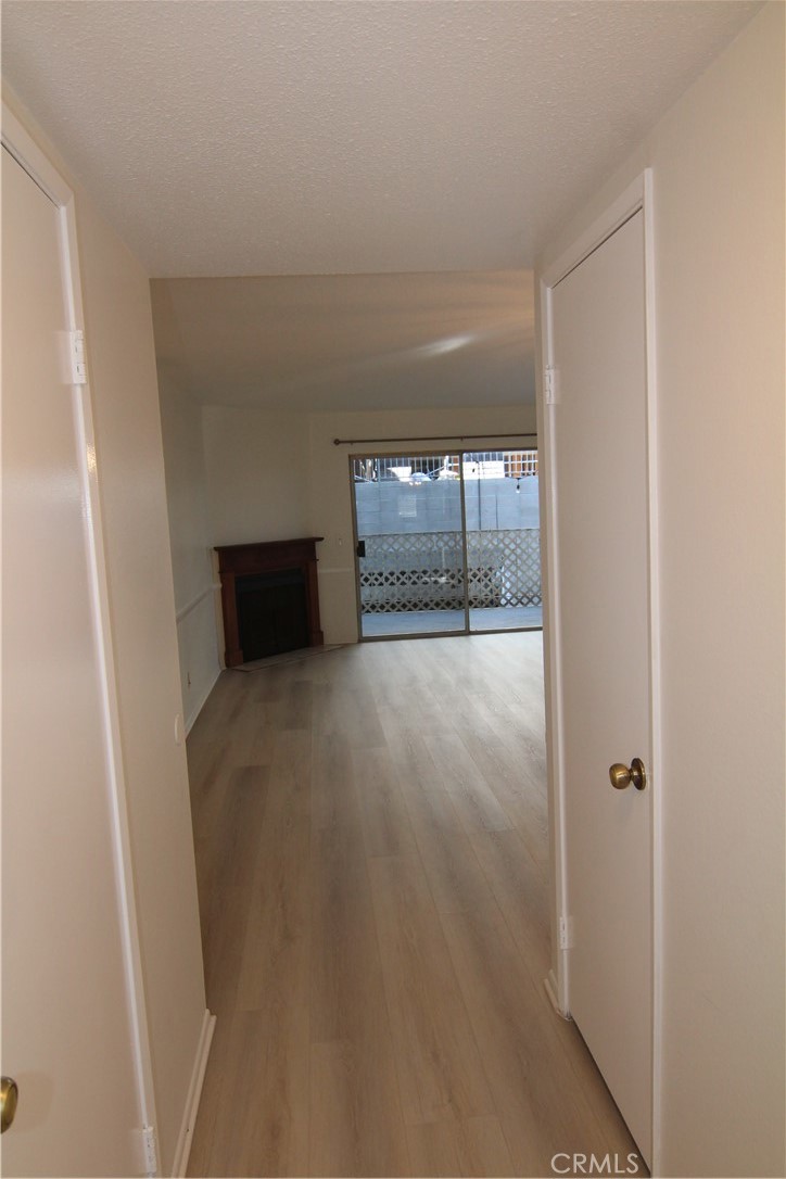 955 East 3rd Street, Unit 204 Long Beach, CA 90802 - Photo 11 of 37 a view of an empty room with wooden floor and a window