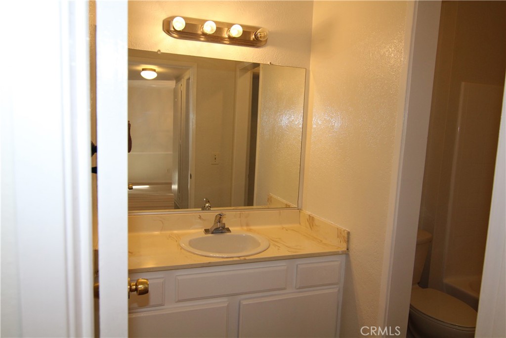 955 East 3rd Street, Unit 204 Long Beach, CA 90802 - Photo 15 of 37 a bathroom with a sink and a mirror
