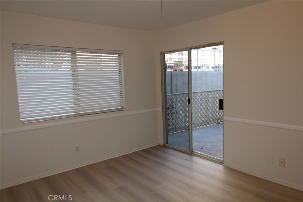 955 East 3rd Street, Unit 204 Long Beach, CA 90802 - Photo 22 of 37 an empty room with wooden floor and windows