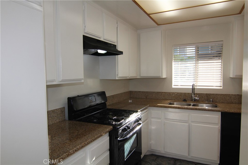 955 East 3rd Street, Unit 204 Long Beach, CA 90802 - Photo 5 of 37 a kitchen with a sink stove and cabinets