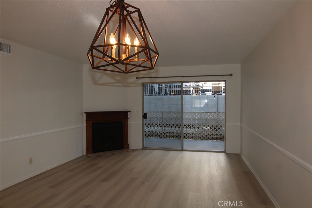 955 East 3rd Street, Unit 204 Long Beach, CA 90802 - Photo 9 of 37 a view of a hallway with wooden floor and white cabinet
