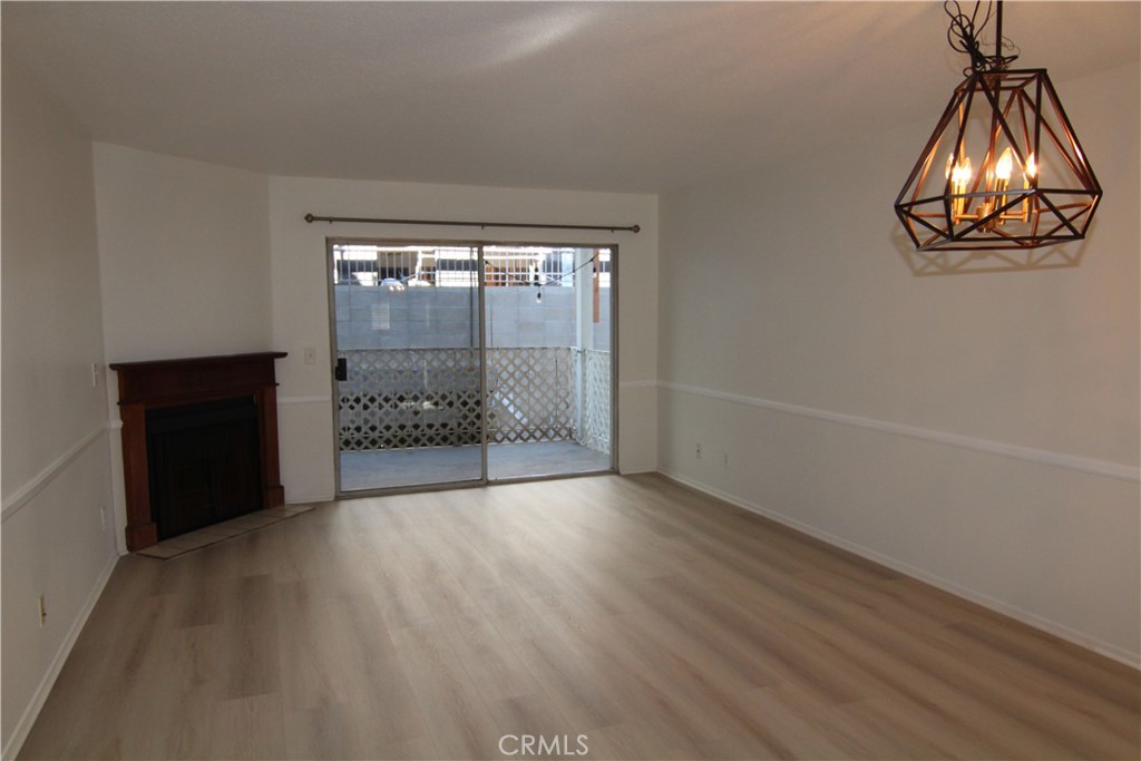 955 East 3rd Street, Unit 204 Long Beach, CA 90802 - Photo 10 of 37 an empty room with a wooden floor and a table