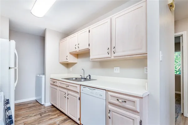 a kitchen with stainless steel appliances white cabinets and a sink