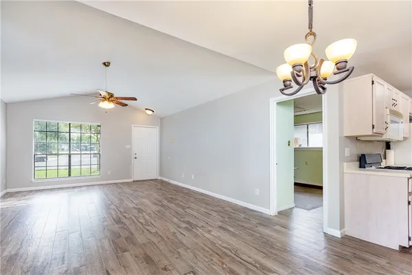 a view of a kitchen with wooden floor and a window