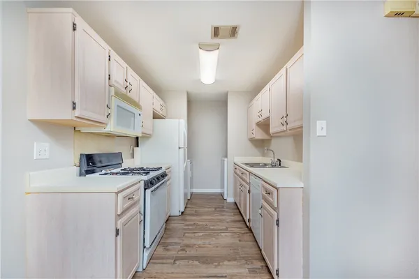 a kitchen with stainless steel appliances a stove top oven