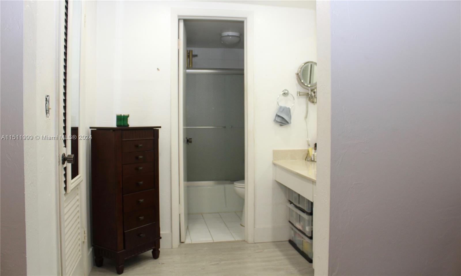10433 Southwest 80th Street Miami, FL 33173 - Photo 13 of 24 a bathroom with a shower and a mirror