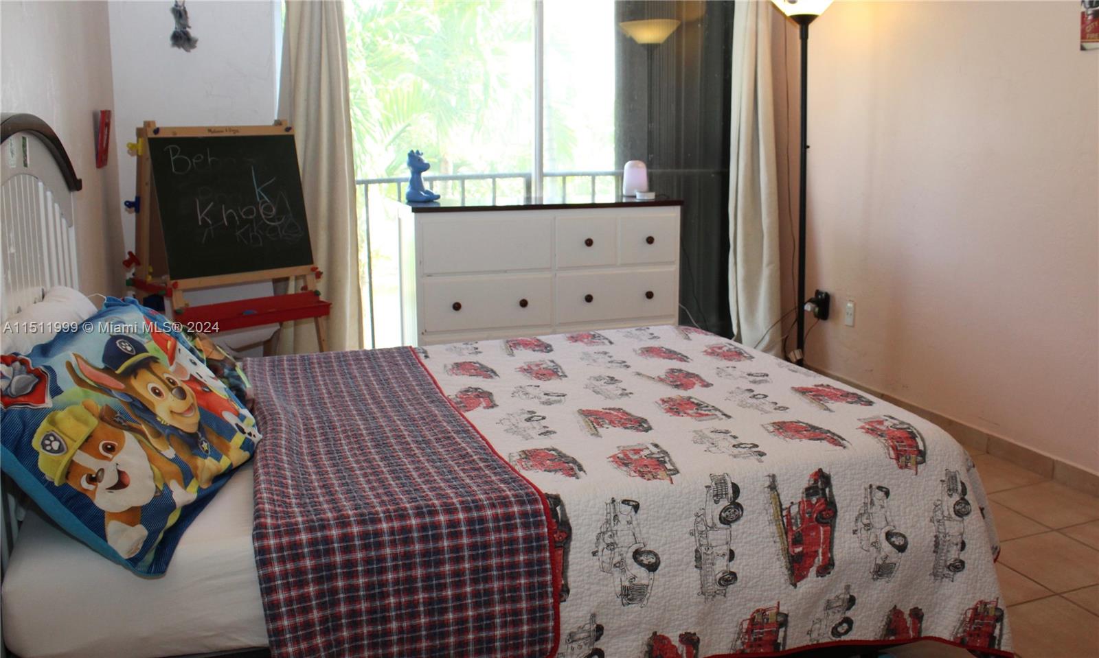 10433 Southwest 80th Street Miami, FL 33173 - Photo 14 of 24 a bedroom with a bed and a window