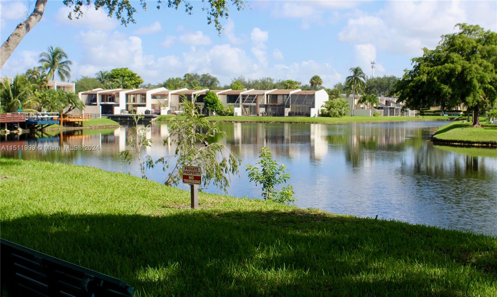 10433 Southwest 80th Street Miami, FL 33173 - Photo 17 of 24 a view of a lake with a yard and large trees