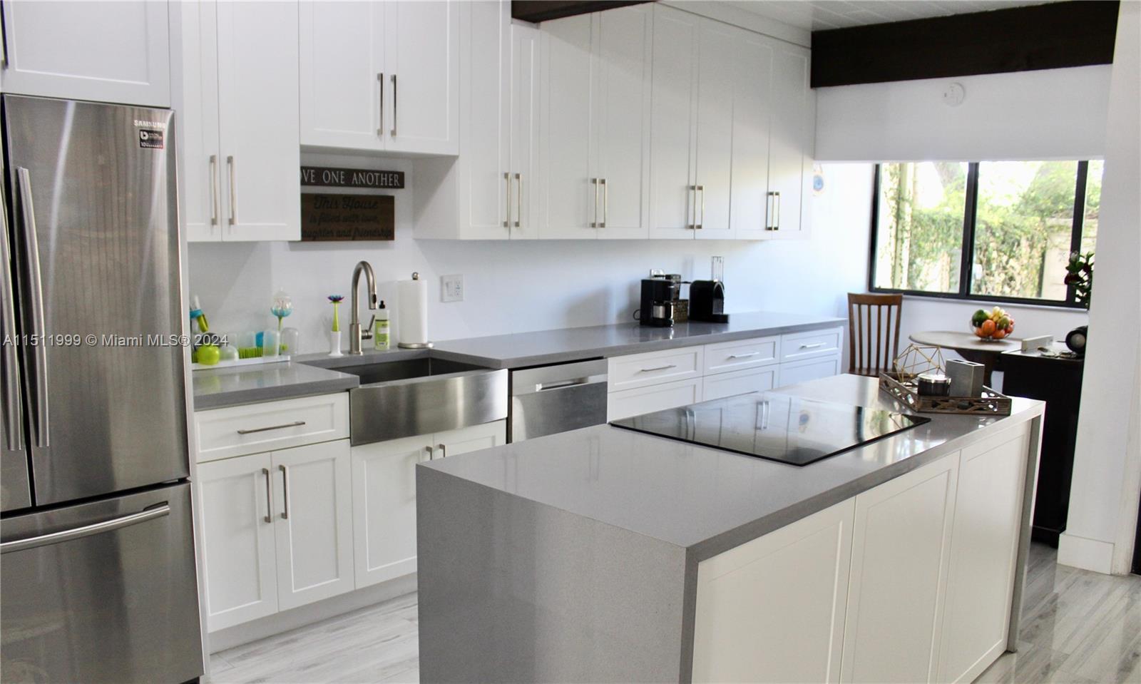 10433 Southwest 80th Street Miami, FL 33173 - Photo 3 of 24 a kitchen with white cabinets and appliances