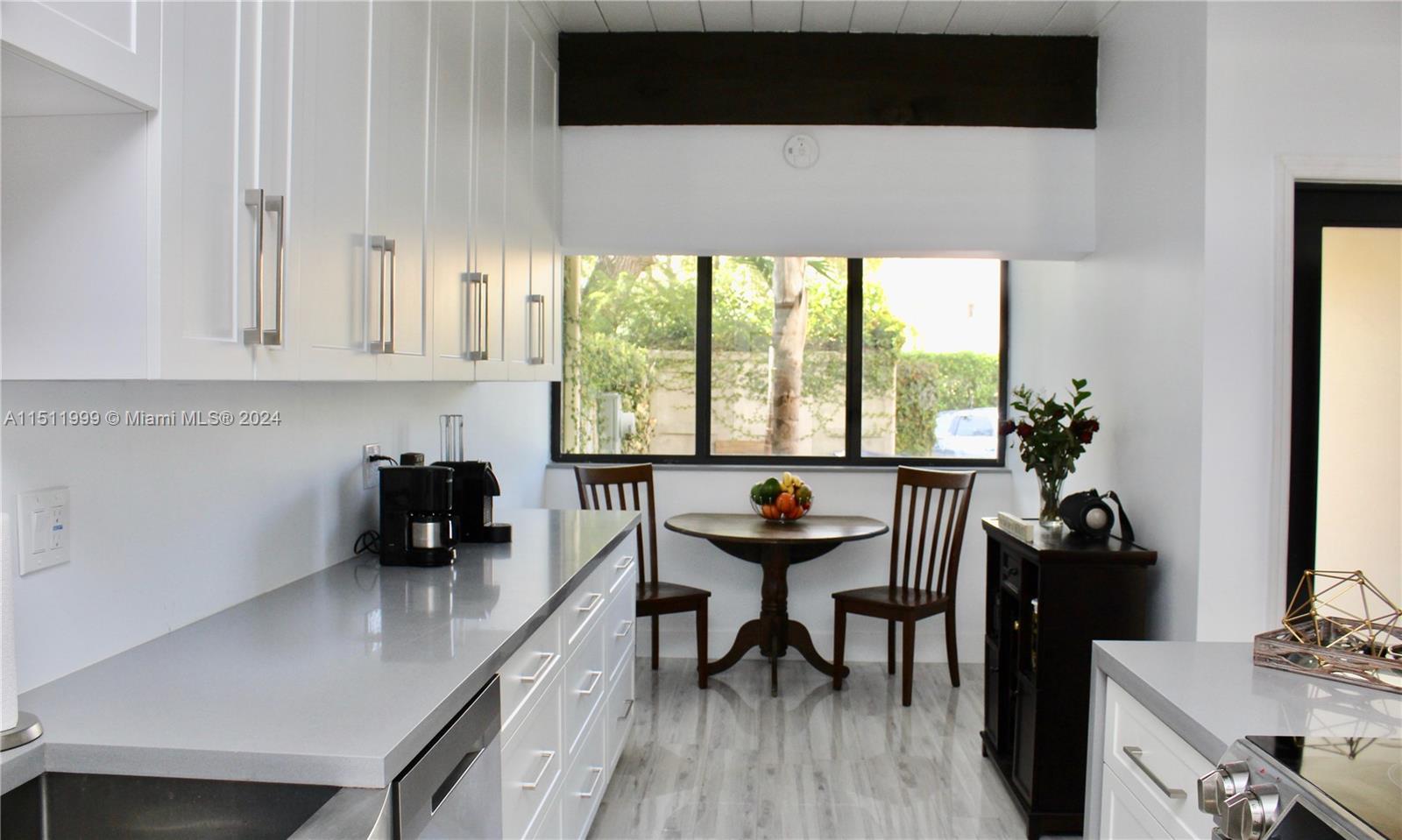 10433 Southwest 80th Street Miami, FL 33173 - Photo 4 of 24 a kitchen with a sink a stove and cabinets