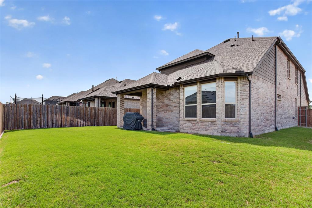 629 Claverton Lane Forney, TX 75126 - Photo 24 of 33 a view of a house with a yard and wooden fence