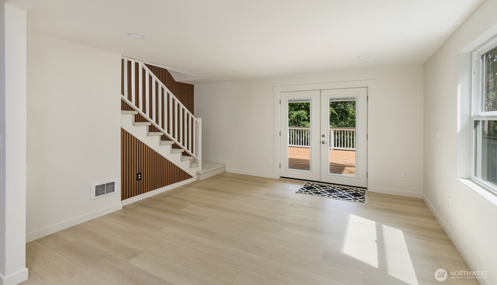 7605 Northeast Hidden Cove Road Bainbridge Island, WA 98110 - Photo 32 of 36 an entryway with wooden floor and stairs