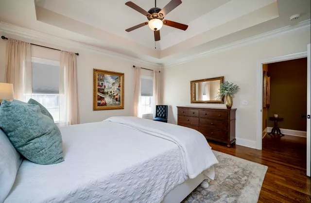 a bed sitting in a bedroom next to a window and dresser