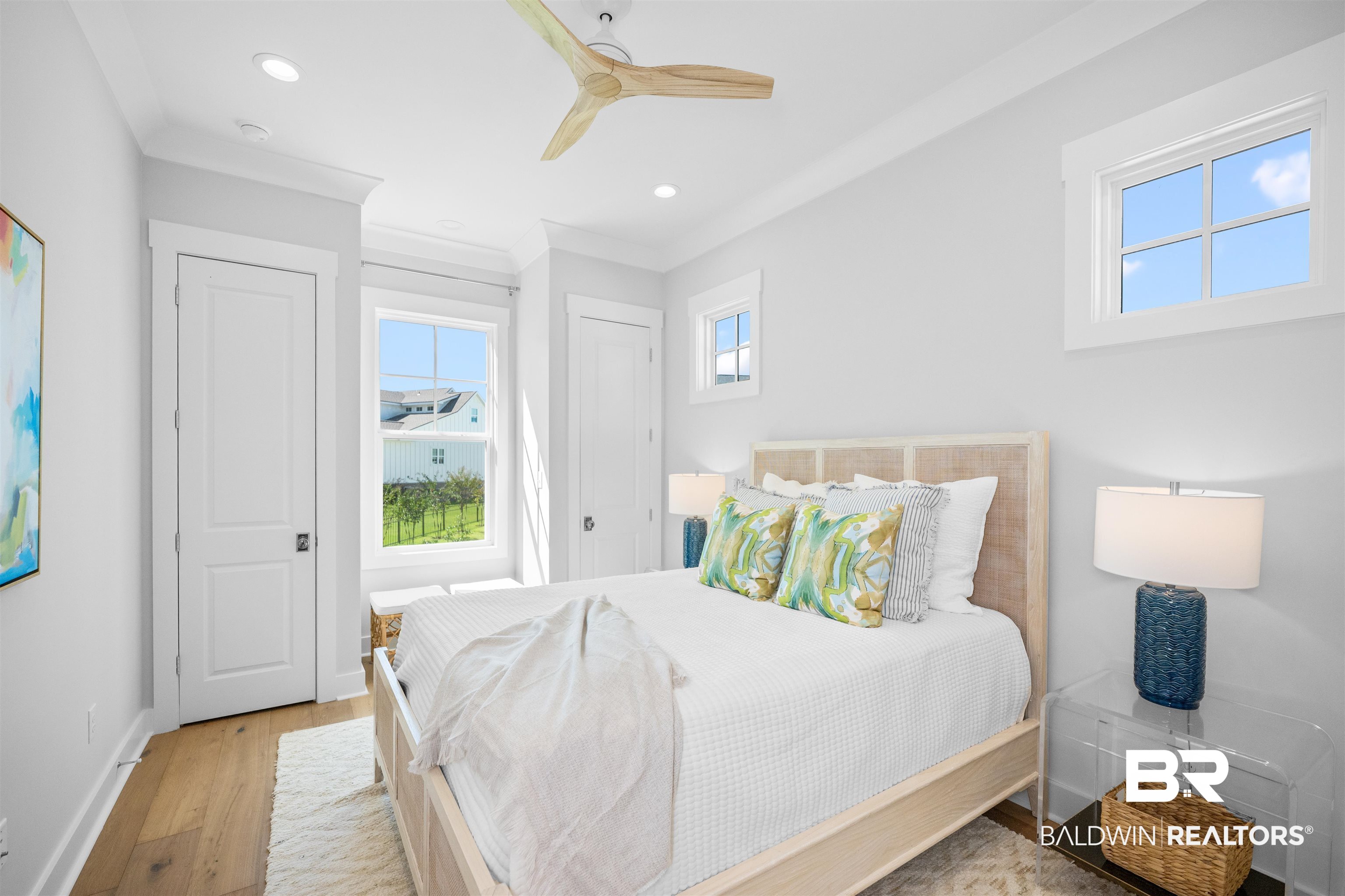 156 Hyacinth Street Fairhope, AL 36532 - Photo 50 of 61 Bedroom with wood finished floors, ceiling fan, recessed lighting, two closets, and crown molding