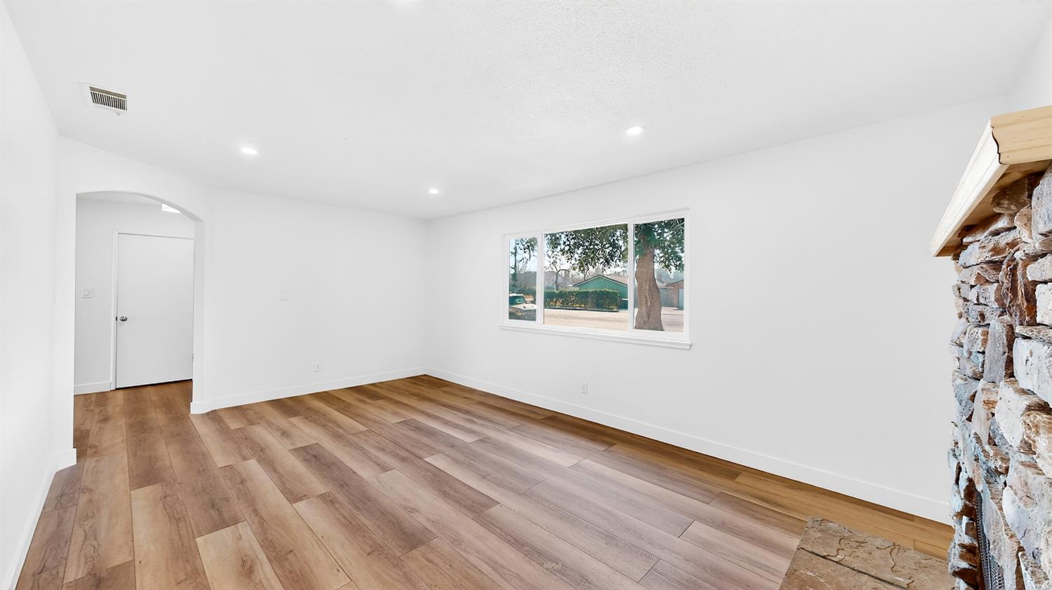 1611 East Olive Avenue Merced, CA 95340 - Photo 14 of 43 a view of empty room with wooden floor and fan