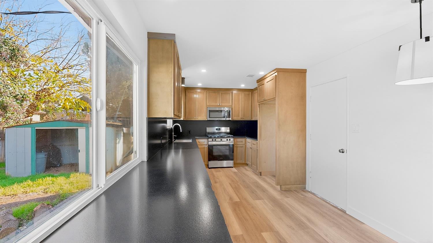 1611 East Olive Avenue Merced, CA 95340 - Photo 17 of 43 a view of a kitchen with a sink and refrigerator