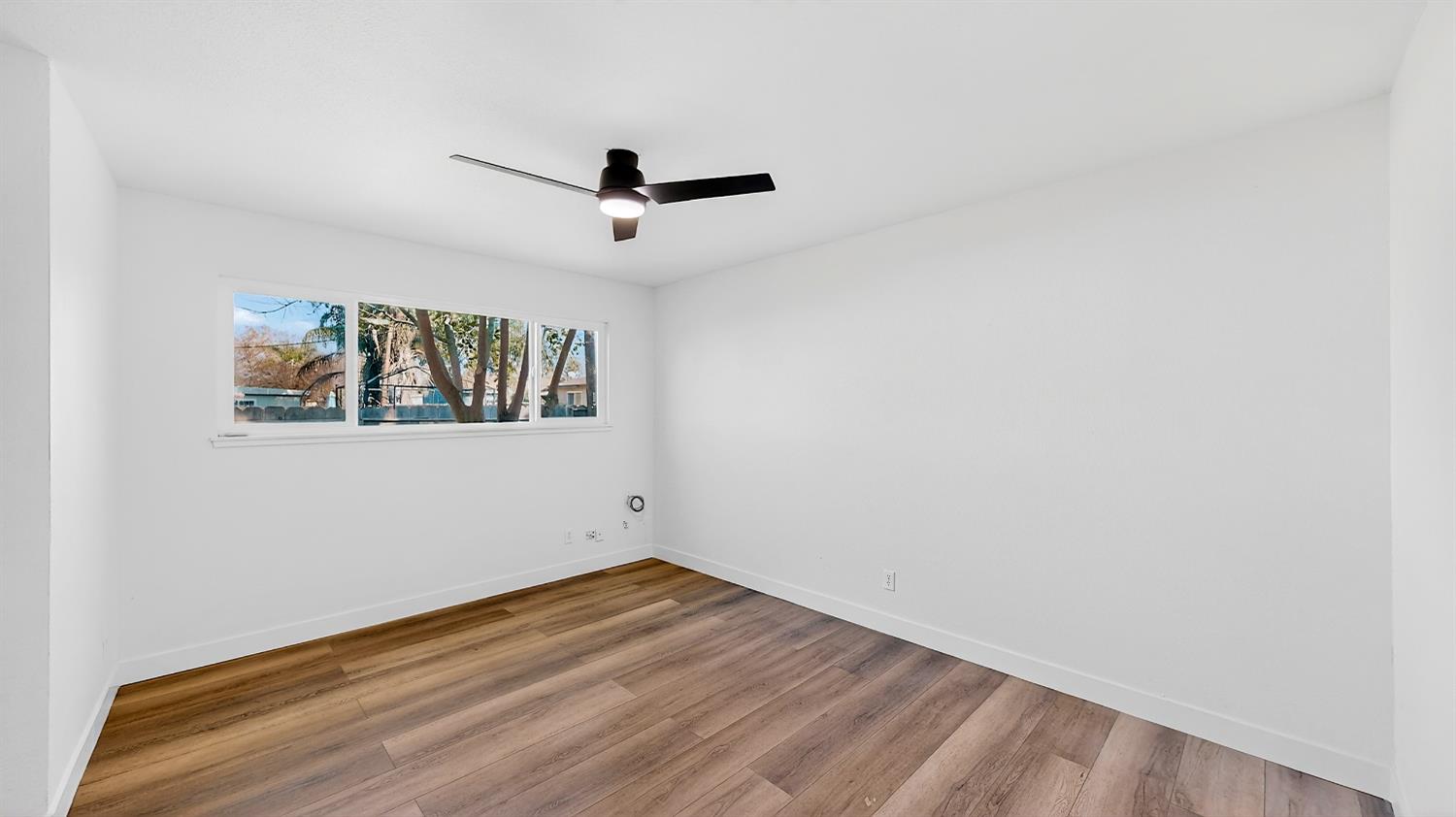 1611 East Olive Avenue Merced, CA 95340 - Photo 26 of 43 a view of empty room with wooden floor