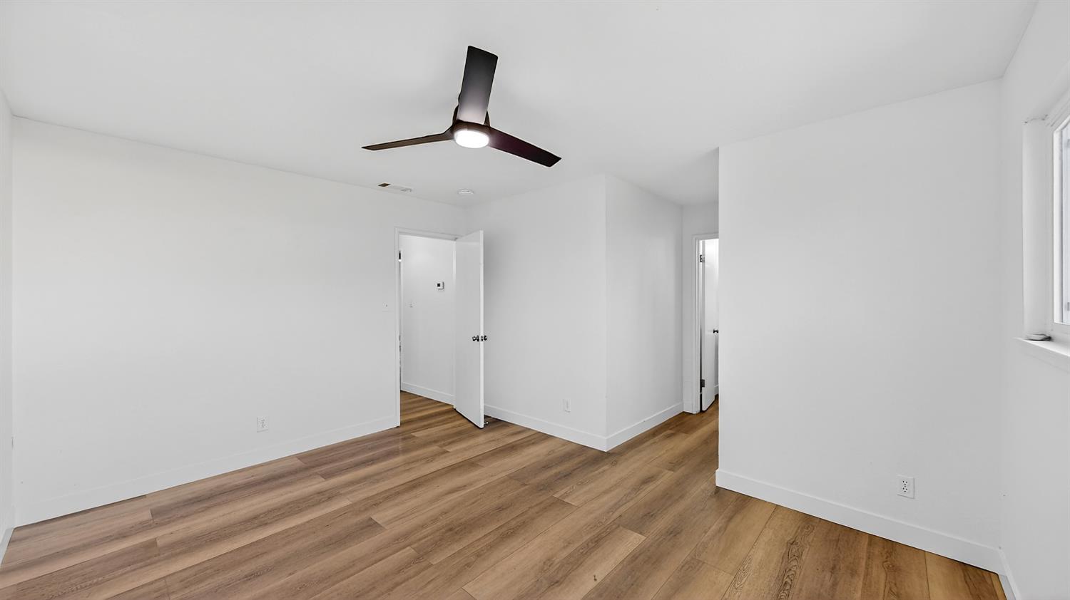 1611 East Olive Avenue Merced, CA 95340 - Photo 28 of 43 a view of empty room with wooden floor and fan