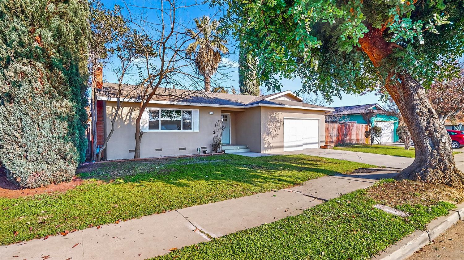 1611 East Olive Avenue Merced, CA 95340 - Photo 3 of 43 a front view of a house with garden