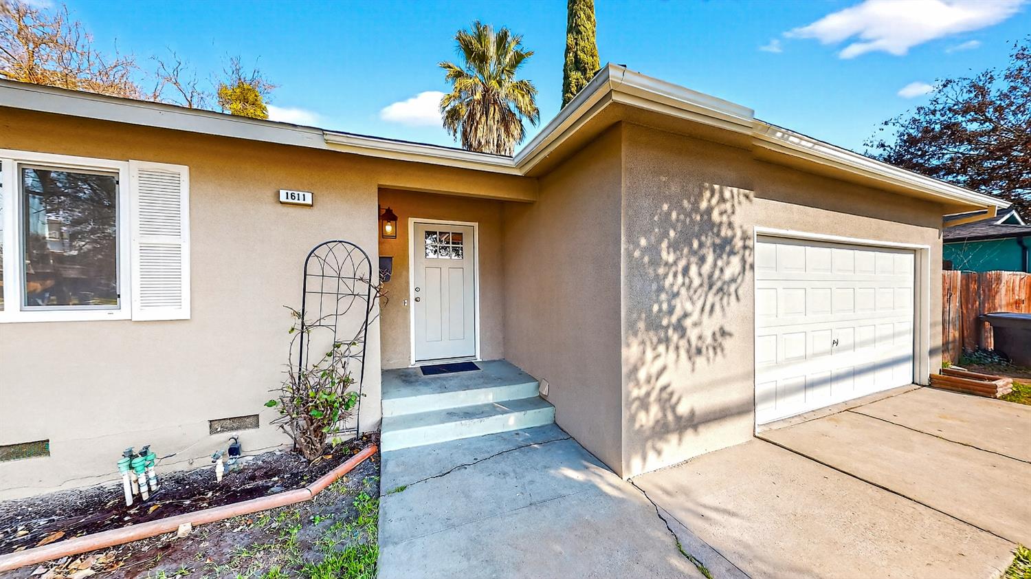 1611 East Olive Avenue Merced, CA 95340 - Photo 5 of 43 a front view of a house with garden