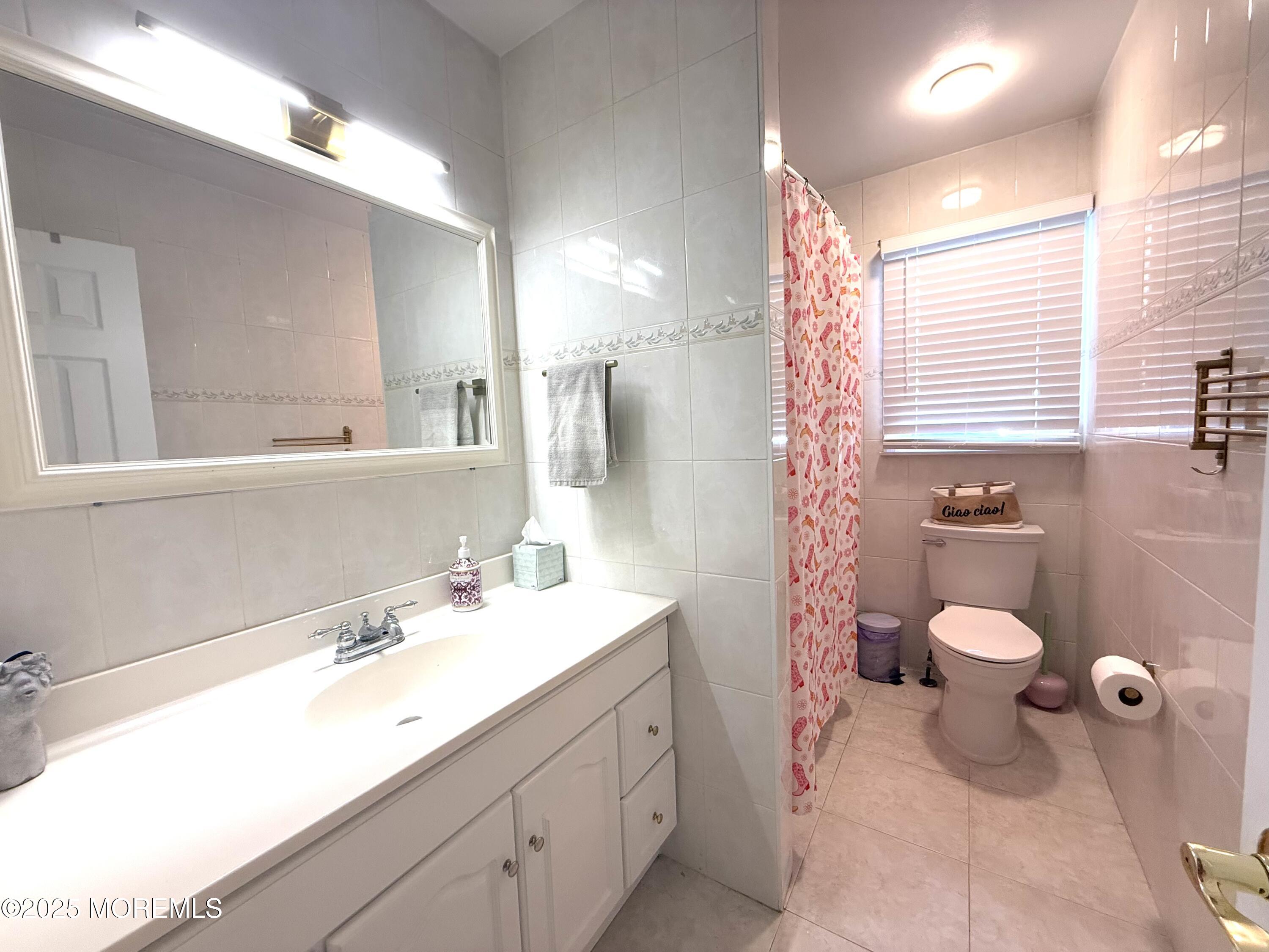 20 Long Road Freehold, NJ 07728 - Photo 13 of 20 a bathroom with a double vanity sink toilet and shower