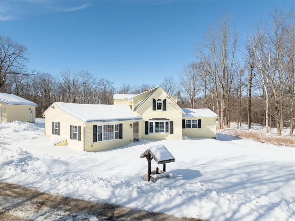 338 Daniel Shays Highway Pelham, MA 01002 - Photo 34 of 41 a front view of a house with a yard covered with snow