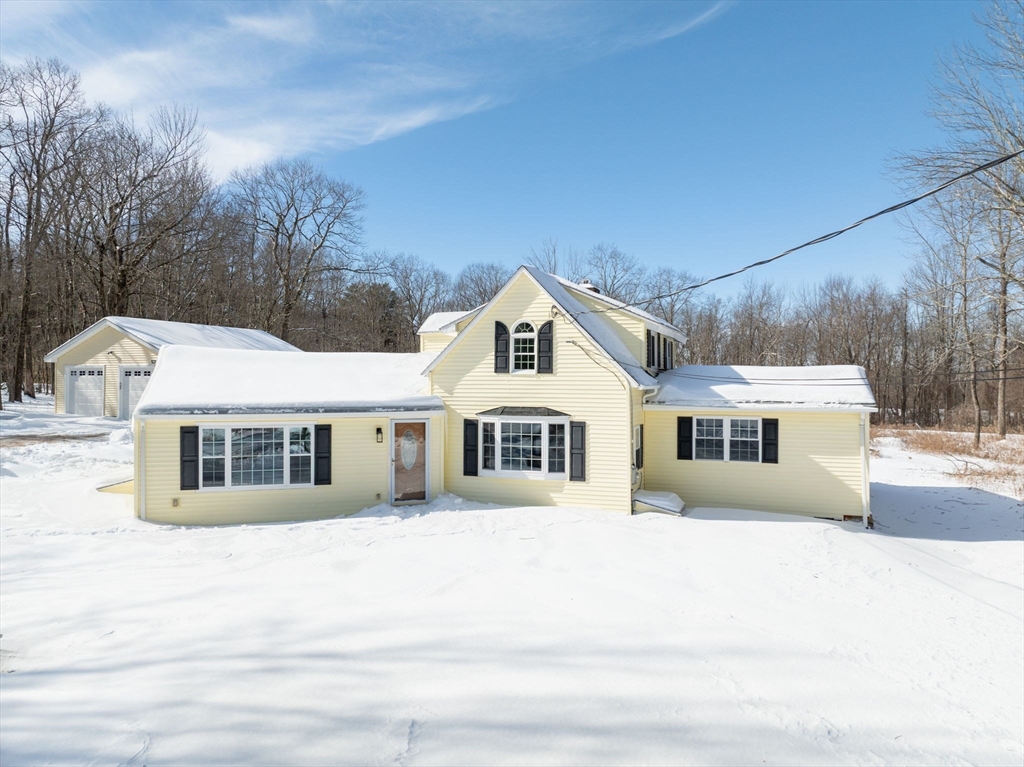 338 Daniel Shays Highway Pelham, MA 01002 - Photo 35 of 41 a front view of a house with a garden and trees