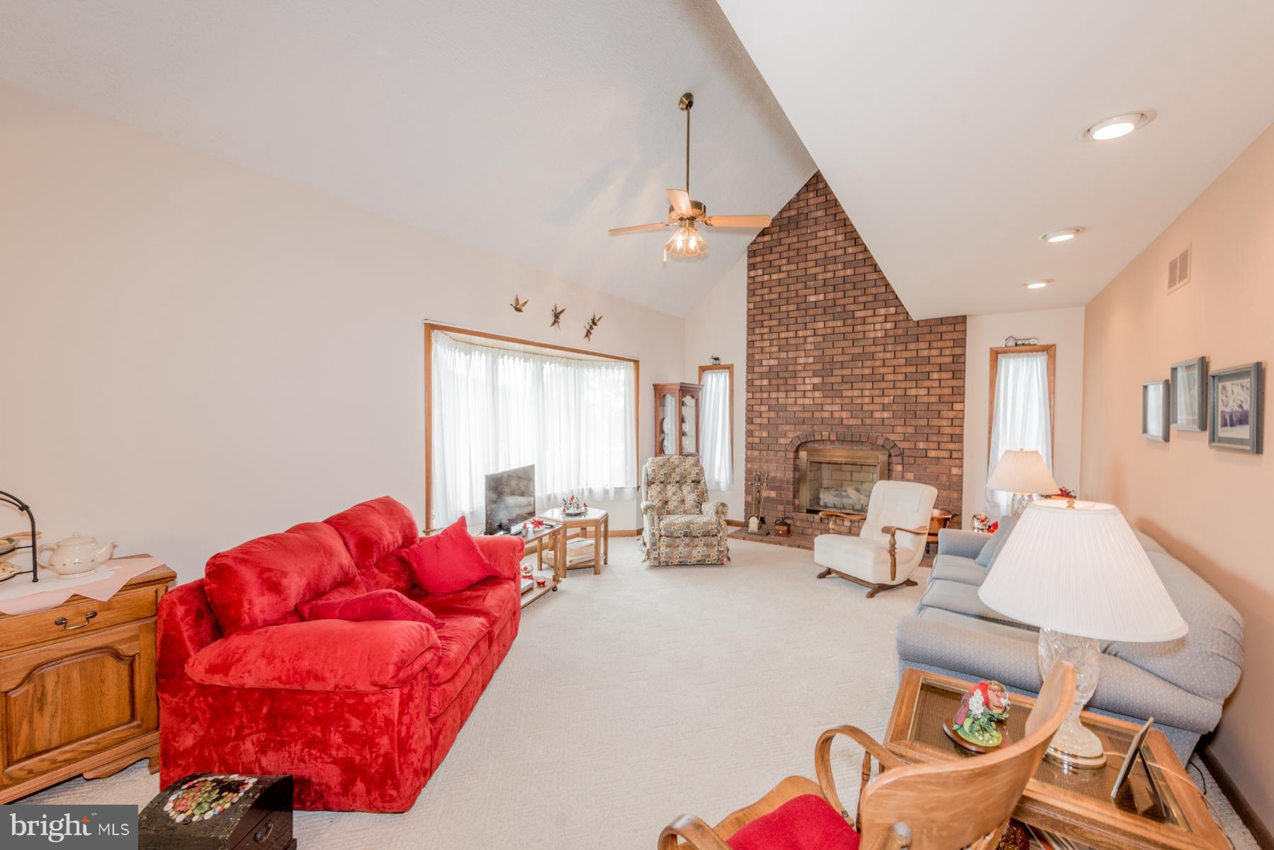 4414 Salem Bottom Road Westminster, MD 21157 - Photo 20 of 30 a living room with furniture a fireplace and a flat screen tv