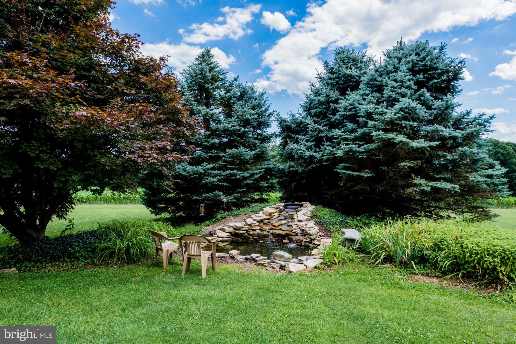 4414 Salem Bottom Road Westminster, MD 21157 - Photo 28 of 30 a garden with a bench and trees