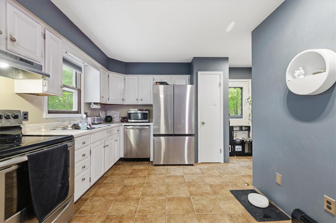 520 Highland Hill Road Jim Thorpe, PA 18235 - Photo 11 of 83 A functional kitchen boasts bright white cabinetry and an array of stainless steel appliances.