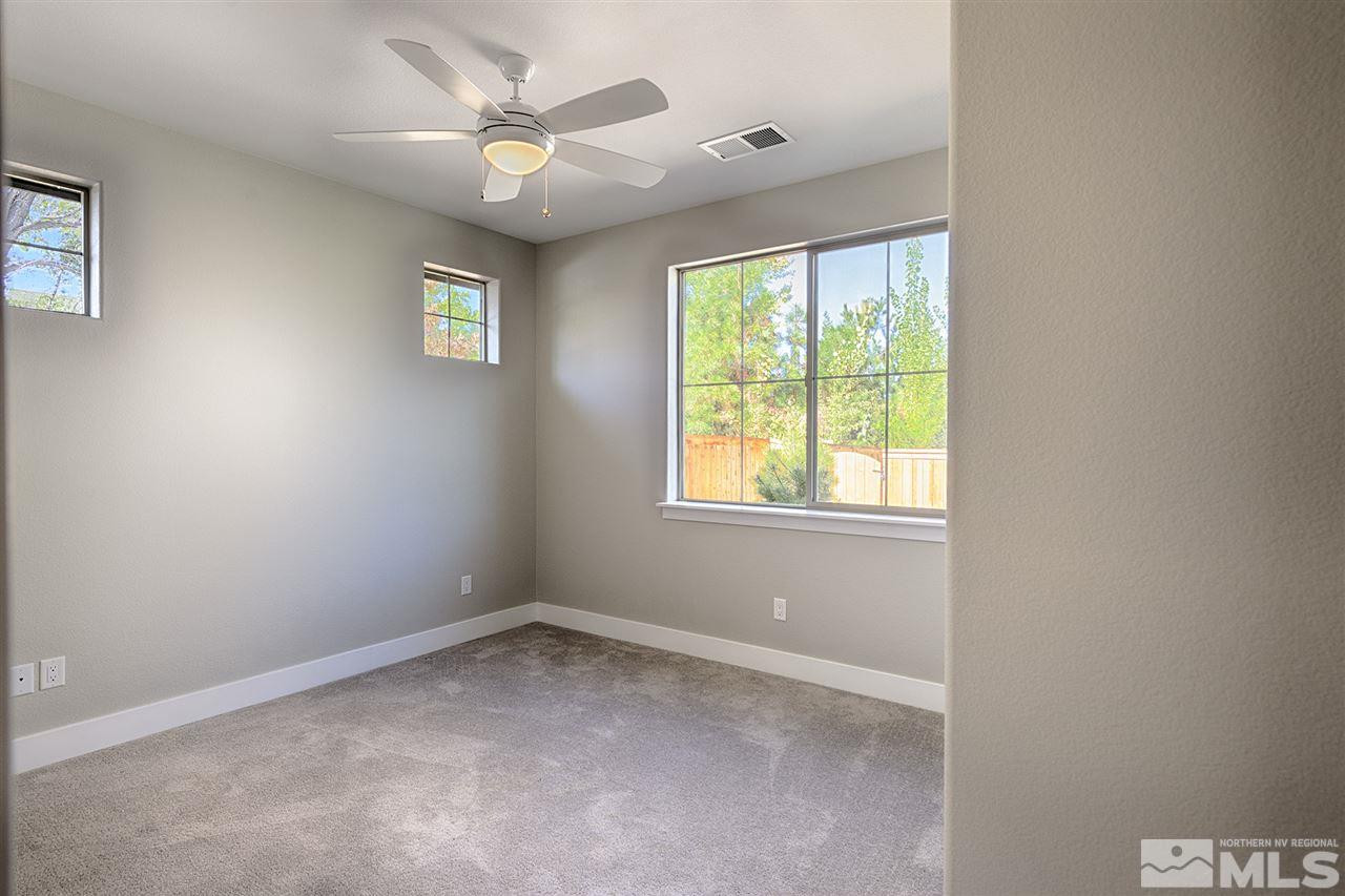 1364 Charles Drive Reno, NV 89509 - Photo 11 of 18 an empty room with a window and a fan