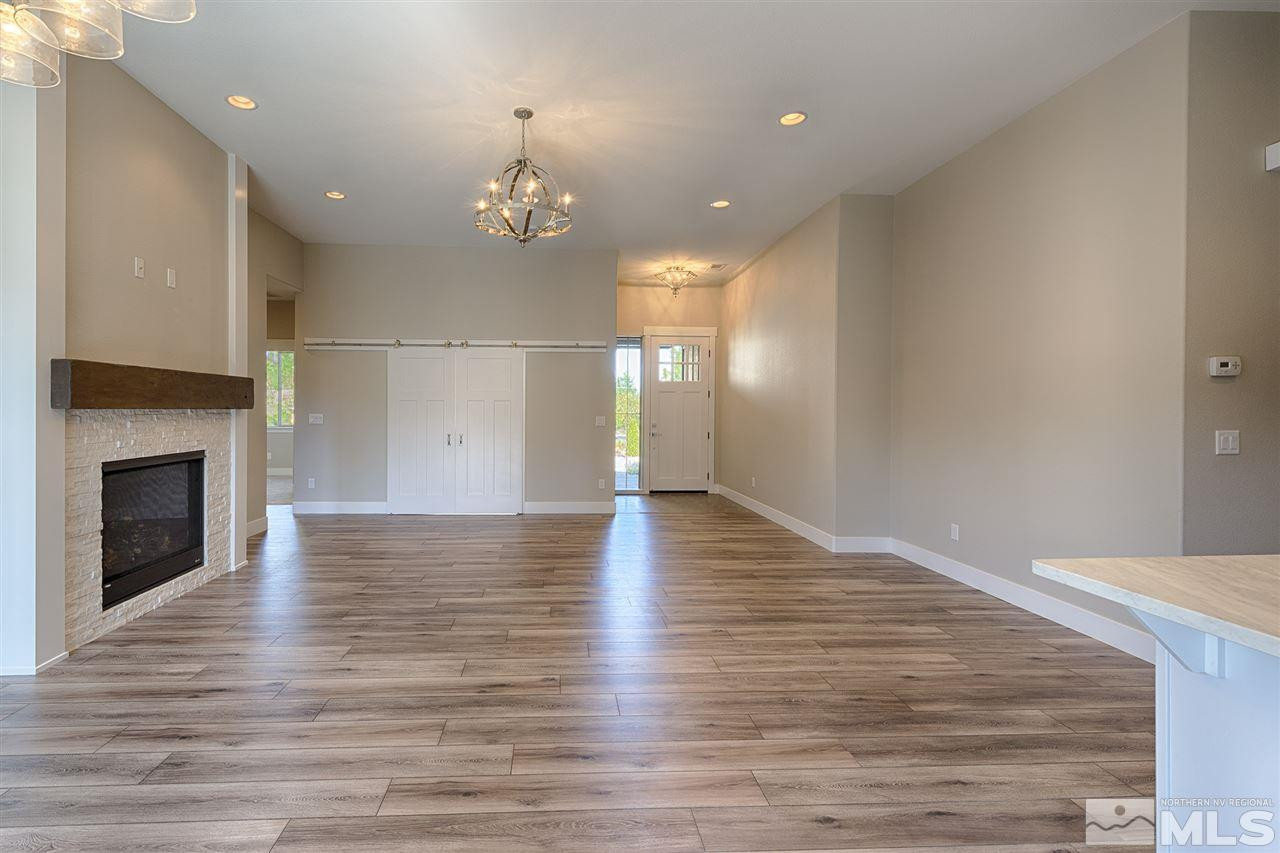 1364 Charles Drive Reno, NV 89509 - Photo 4 of 18 a view of an empty room with wooden floor and a fireplace