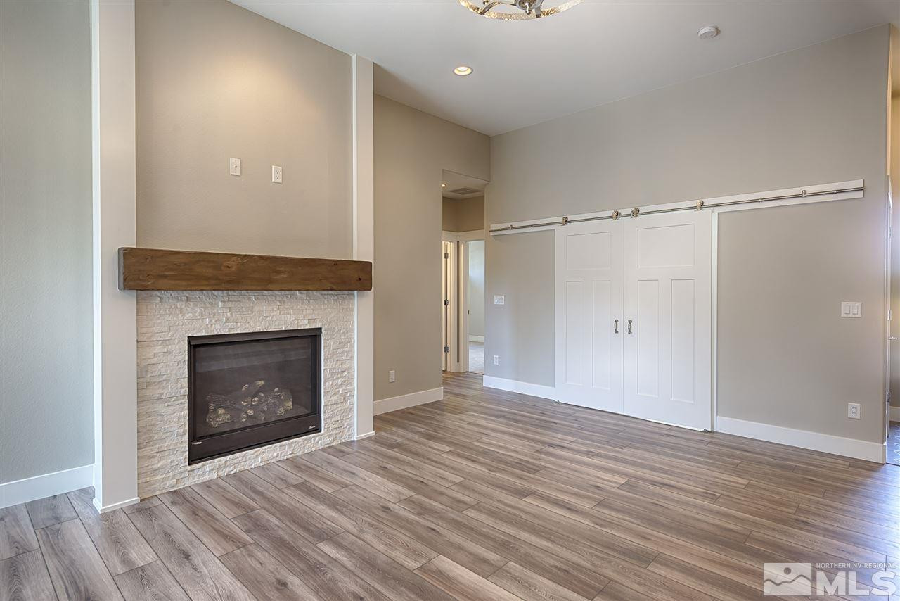 1364 Charles Drive Reno, NV 89509 - Photo 5 of 18 a view of an empty room with wooden floor fireplace and a window