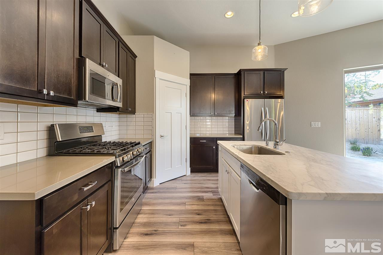 1364 Charles Drive Reno, NV 89509 - Photo 8 of 18 a kitchen with stainless steel appliances granite countertop a stove a sink and a refrigerator