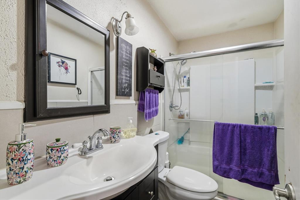 1571 VZ County Road Ben Wheeler, TX 75754 - Photo 13 of 39 a bathroom with a toilet a sink and a mirror