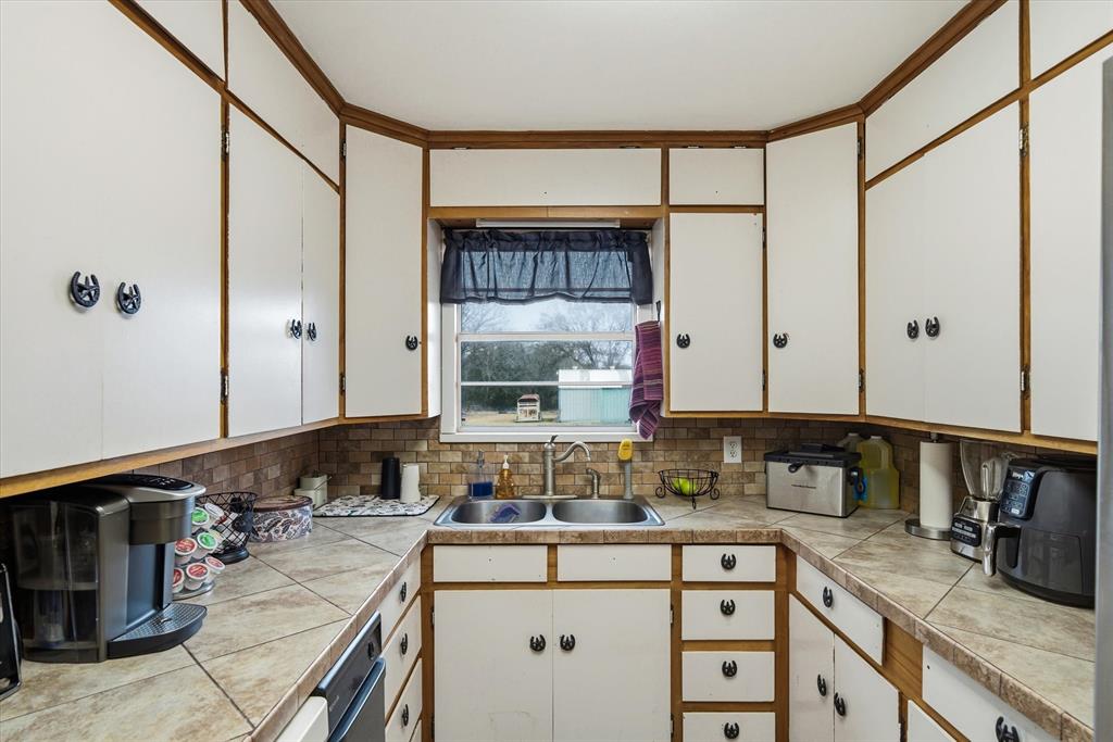 1571 VZ County Road Ben Wheeler, TX 75754 - Photo 18 of 39 a kitchen with a sink cabinets and window