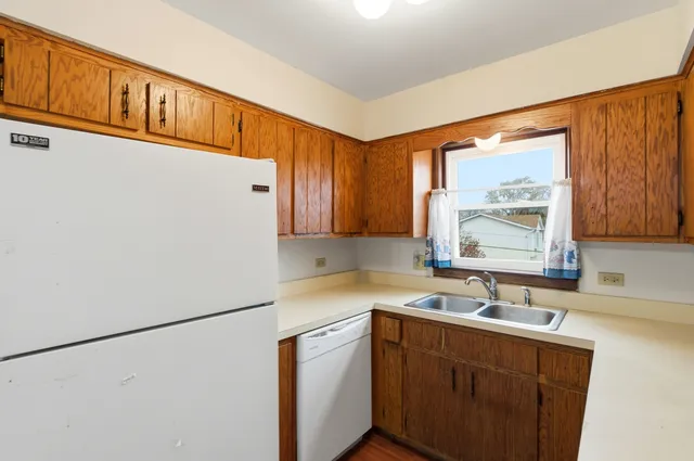 a kitchen with a sink a window and cabinets