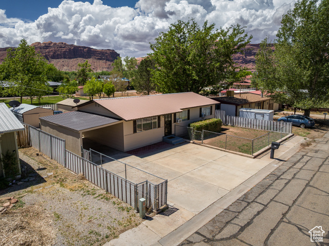 527 Palisade Drive Moab, UT 84532 - Photo 32 of 51 Single story home featuring a mountain view, metal roof, fence, and driveway