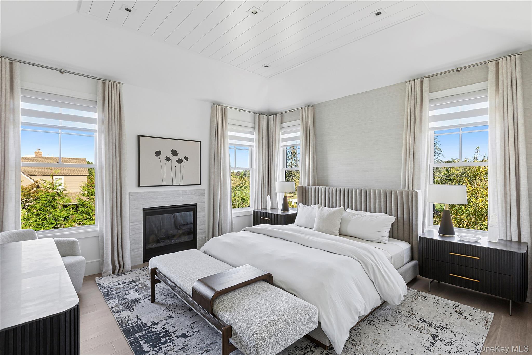 8 Magnolia Drive, Unit 2A Water Mill, NY 11976 - Photo 11 of 39 a bedroom with a bed a fireplace and a window