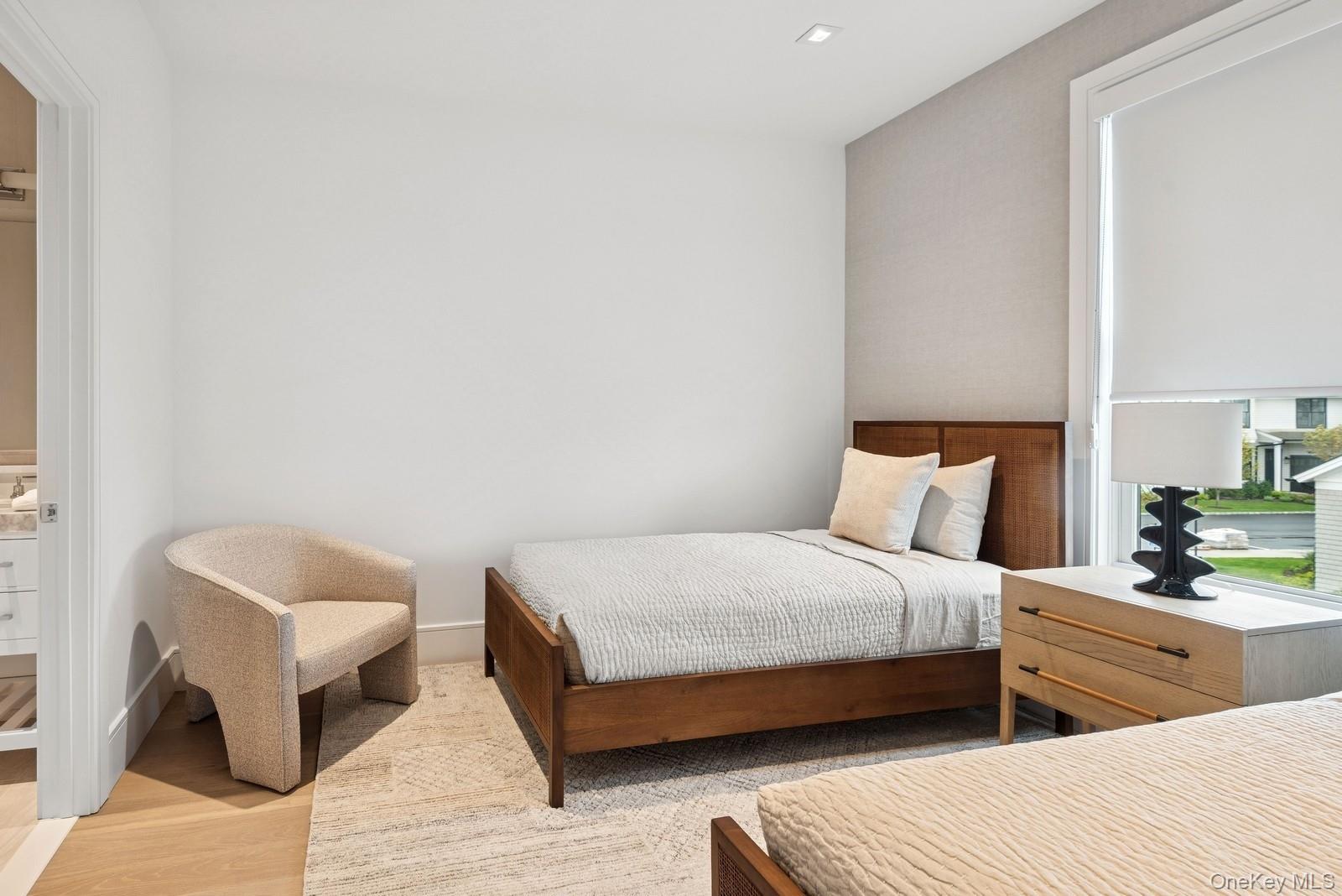 8 Magnolia Drive, Unit 2A Water Mill, NY 11976 - Photo 18 of 39 a bedroom with a bed and a night stand