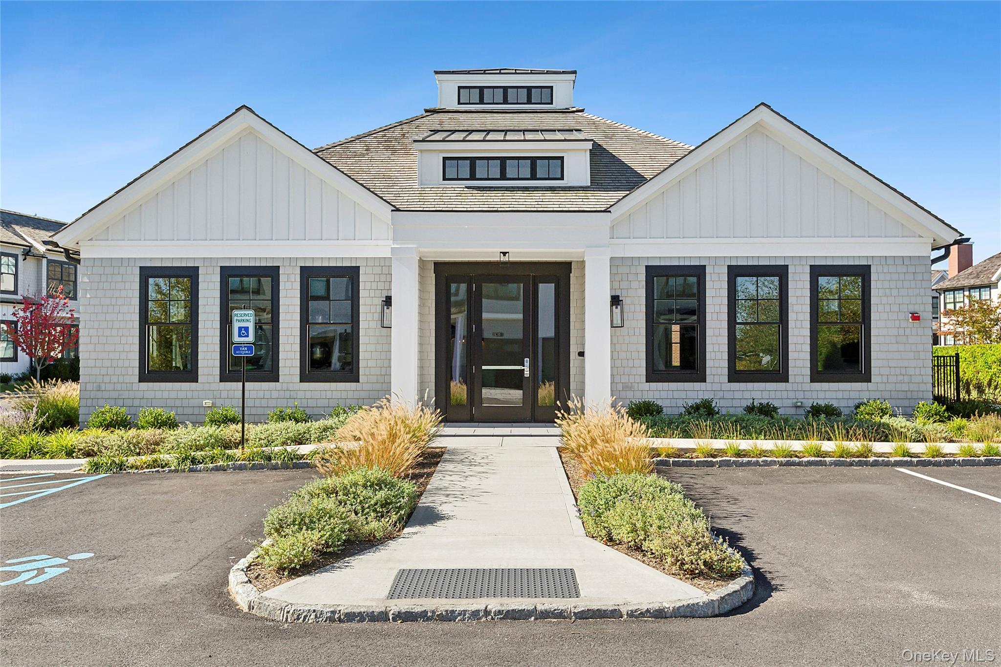 8 Magnolia Drive, Unit 2A Water Mill, NY 11976 - Photo 29 of 39 a front view of a house with a garden and plants