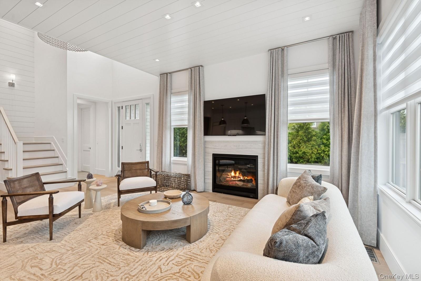 8 Magnolia Drive, Unit 2A Water Mill, NY 11976 - Photo 3 of 39 a living room with furniture and a fireplace