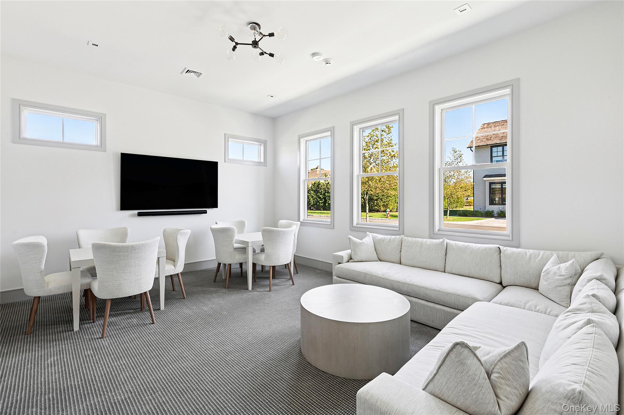 8 Magnolia Drive, Unit 2A Water Mill, NY 11976 - Photo 30 of 39 a living room with furniture a flat screen tv and a window
