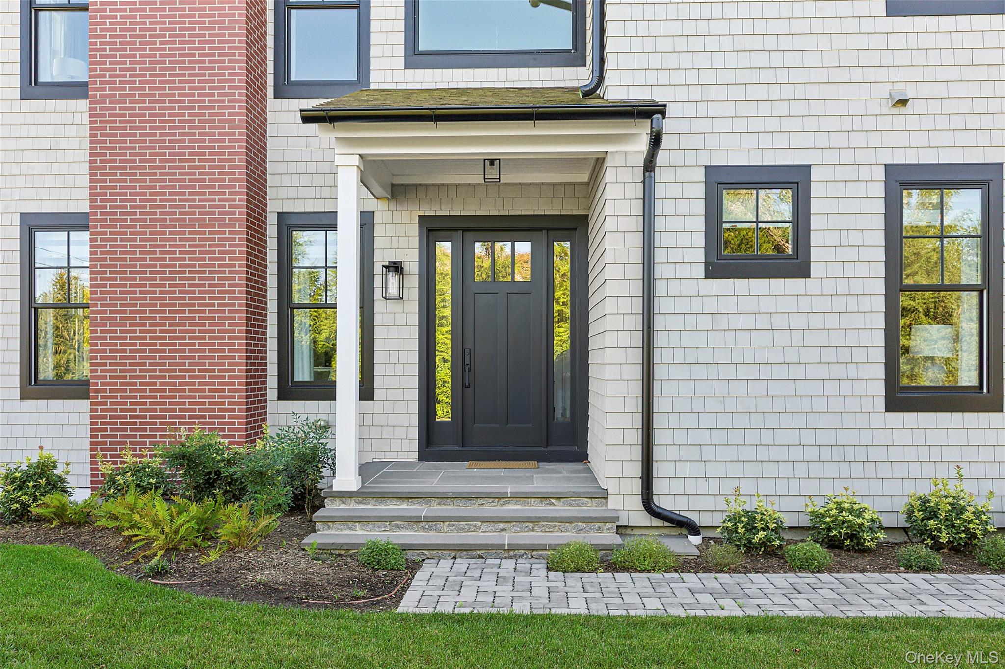 8 Magnolia Drive, Unit 2A Water Mill, NY 11976 - Photo 35 of 39 a front view of a house with garden