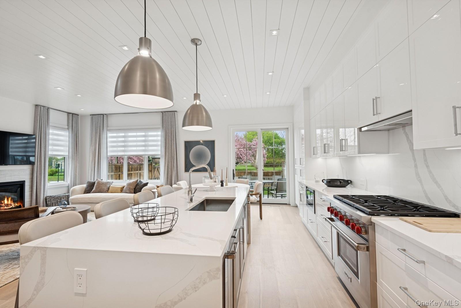 8 Magnolia Drive, Unit 2A Water Mill, NY 11976 - Photo 39 of 39 a kitchen with stainless steel appliances granite countertop a sink a stove and a wooden floors