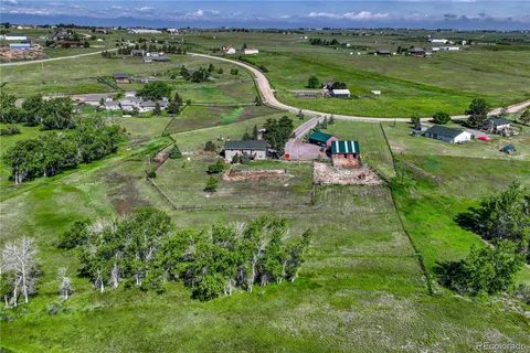 an aerial view of a golf course with chairs